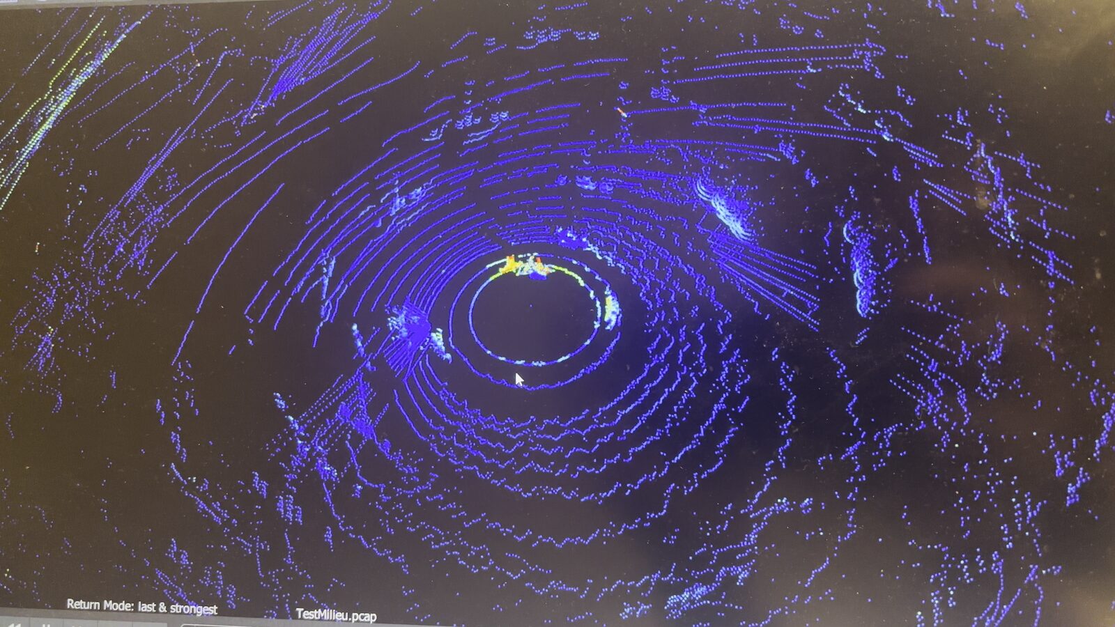 Nuage de points bleu généré par le LiDAR, montrant les corps et le sol captés en trois dimensions.