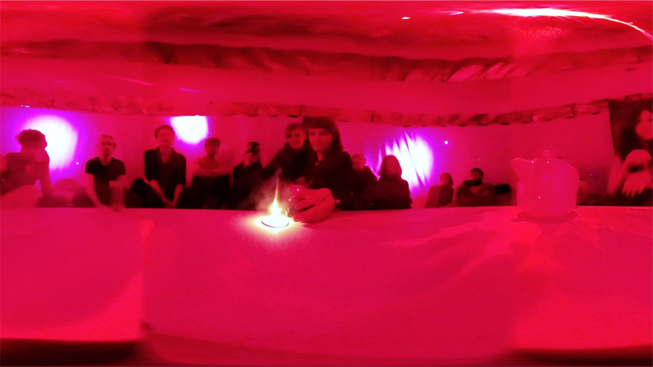 360 image of the pint-tinted Dream Room with a candle in the center. People are all lined up against the walls.